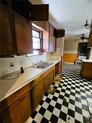 a kitchen with a sink a stove a refrigerator and cabinets