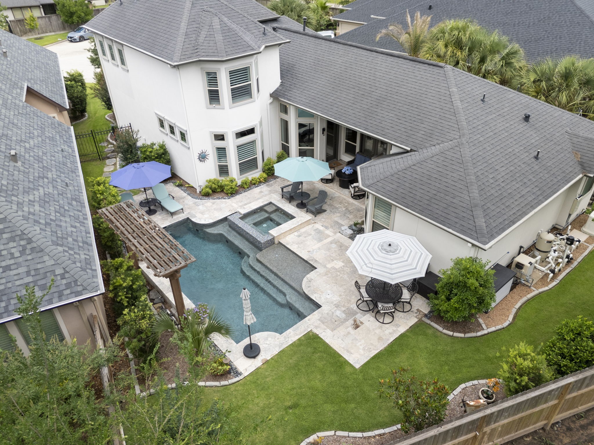 25607 Muirfield Bend Court Spring, TX 77389 - Photo 29 of 30 Bird's-eye view of the private backyard retreat showcasing the custom pool and spa, expansive travertine patios, multiple entertaining spaces, and thoughtfully designed landscaping that creates a true resort-style setting.