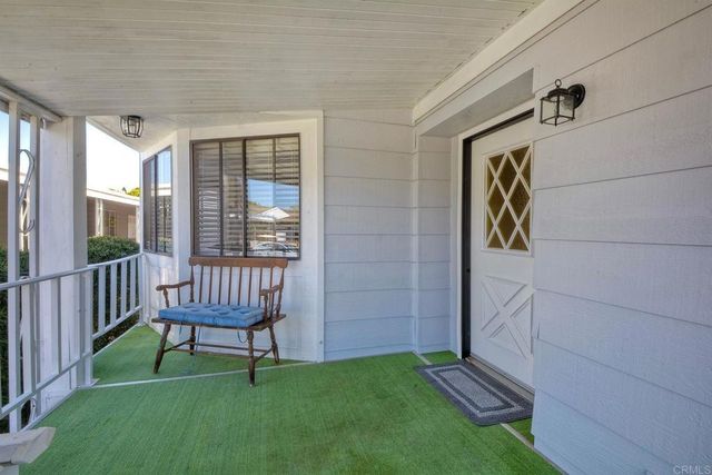 a kitchen with stainless steel appliances granite countertop a refrigerator a sink dishwasher a stove and white countertops with wooden floor