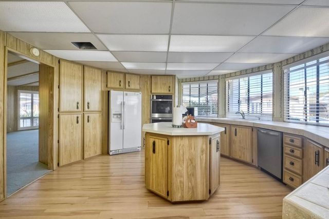 a utility room with cabinets washer and dryer