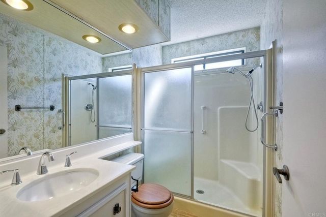 an empty room with a mirror and a walk in closet