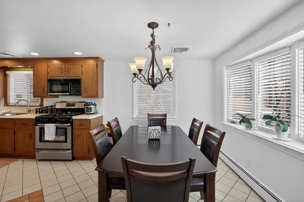 a kitchen with a kitchen island hardwood floor and a sink