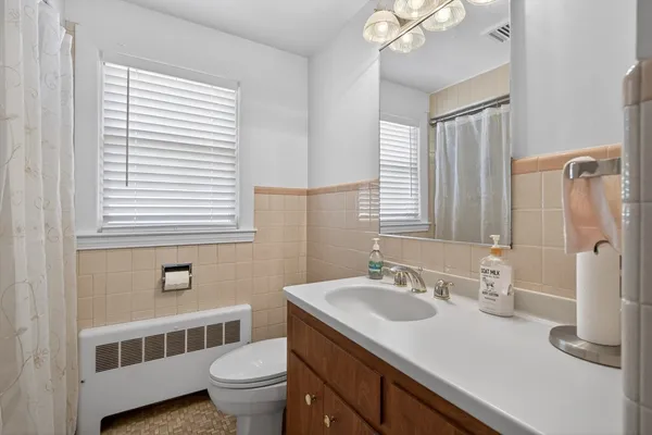 a bathroom with a sink a toilet and a mirror