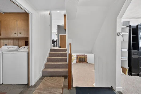 a view of entryway and hall with wooden floor