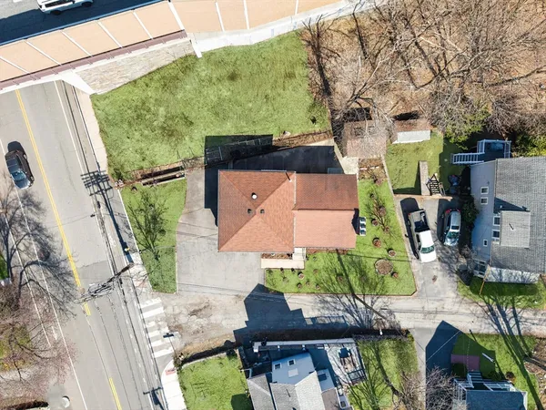 an aerial view of a house with garden space and street view