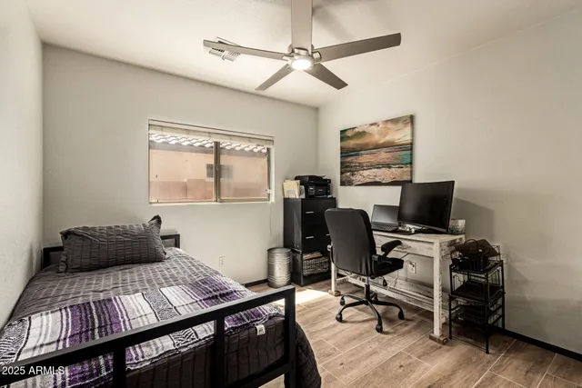 a bedroom with a bed and wooden floor