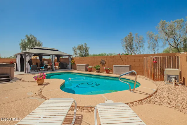 a view of a swimming pool with lounge chairs