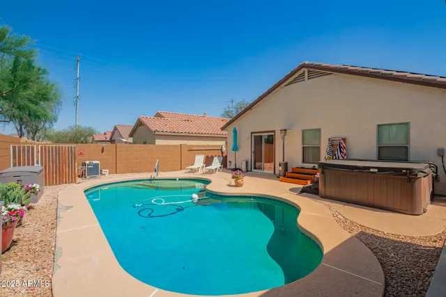 a view of a house with backyard patio and sitting area