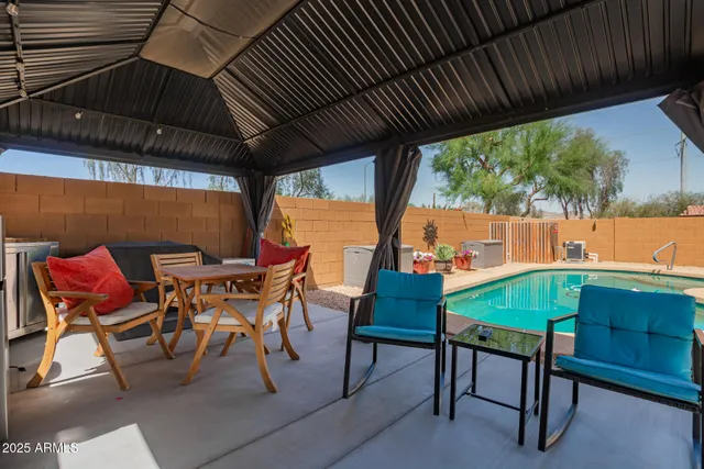 a patio with table and chairs