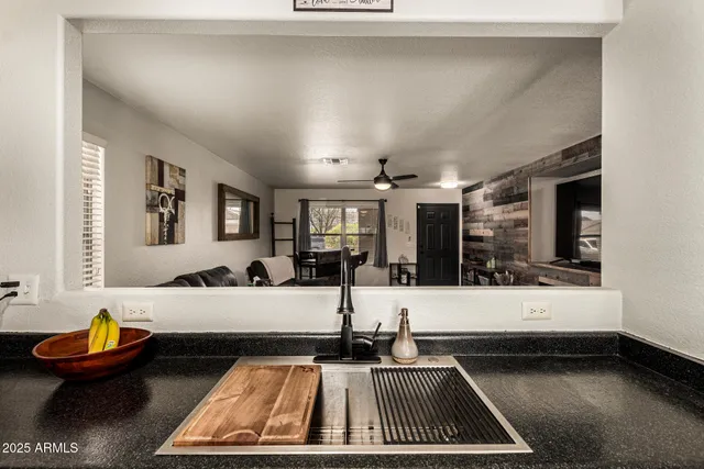a living room with furniture and view of kitchen