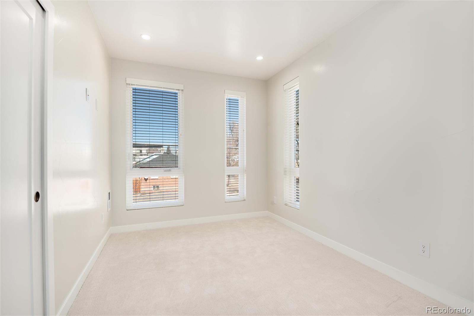 1395 Xavier Street, Unit 2 Denver, CO 80204 - Photo 4 of 14 an empty room with windows and closet