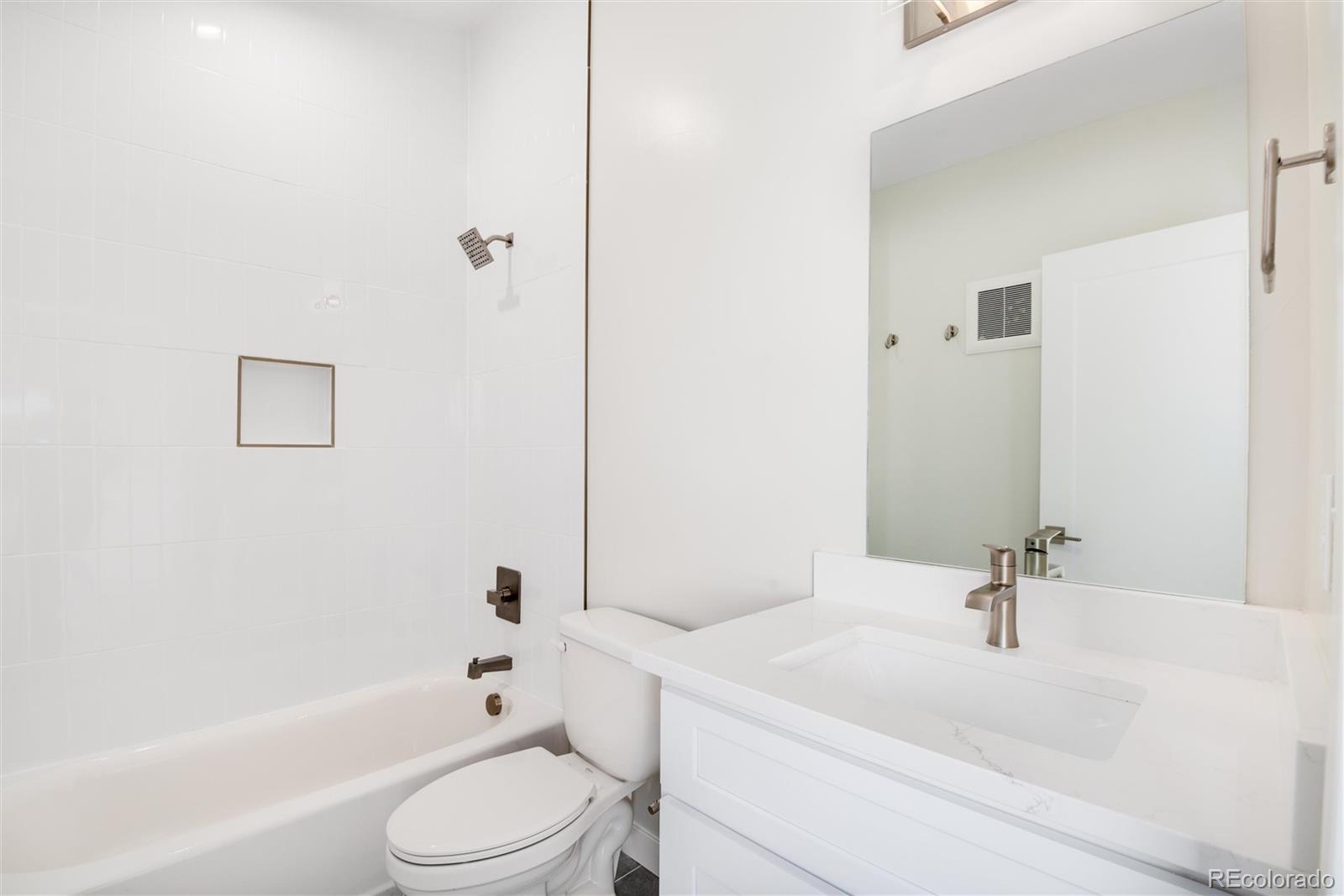 1395 Xavier Street, Unit 2 Denver, CO 80204 - Photo 9 of 14 a bathroom with a sink a toilet and shower