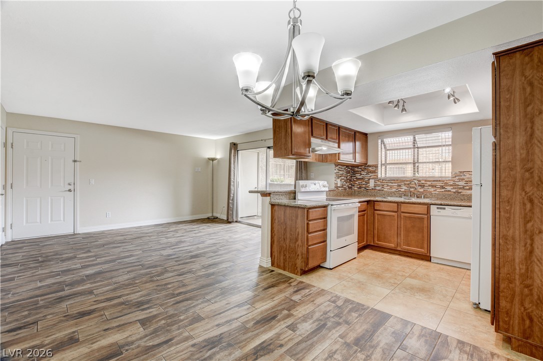 7200 West Pirates Cove Road, Unit 1026 Las Vegas, NV 89145 - Photo 10 of 35 This open concept kitchen and living area features warm wood flooring and ample natural light.
