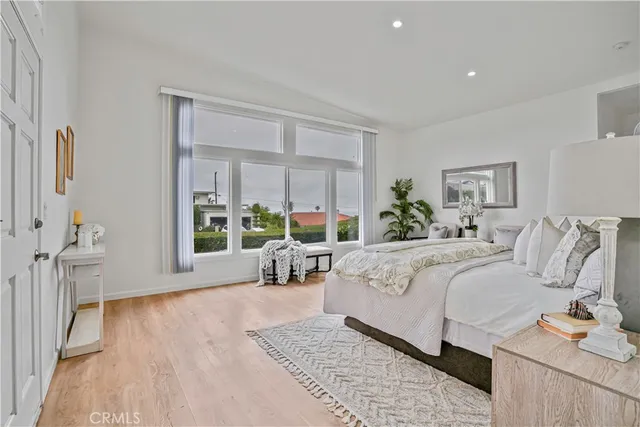 a bed room with bed and a large window