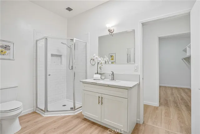 a spacious bathroom with a granite countertop sink toilet and shower