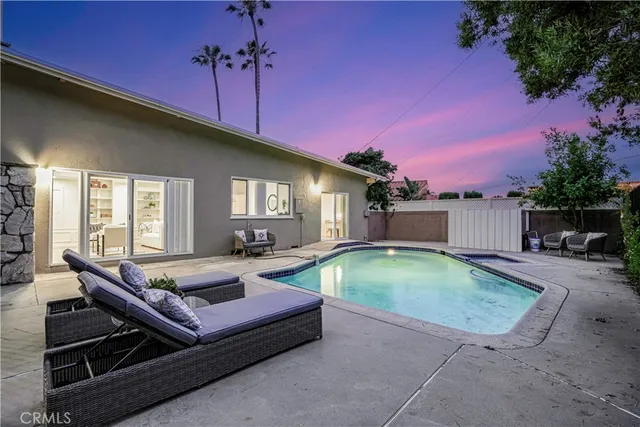 a backyard of a house with yard fire pit and outdoor seating