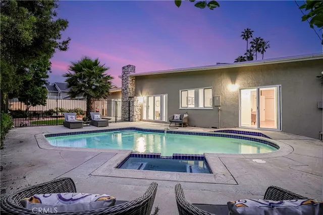 a front view of a house with swimming pool yard and outdoor seating