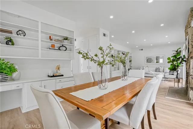 a dining room with kitchen island a table and chairs in it