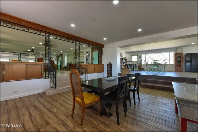 a bed sitting in a spacious bedroom next to a window