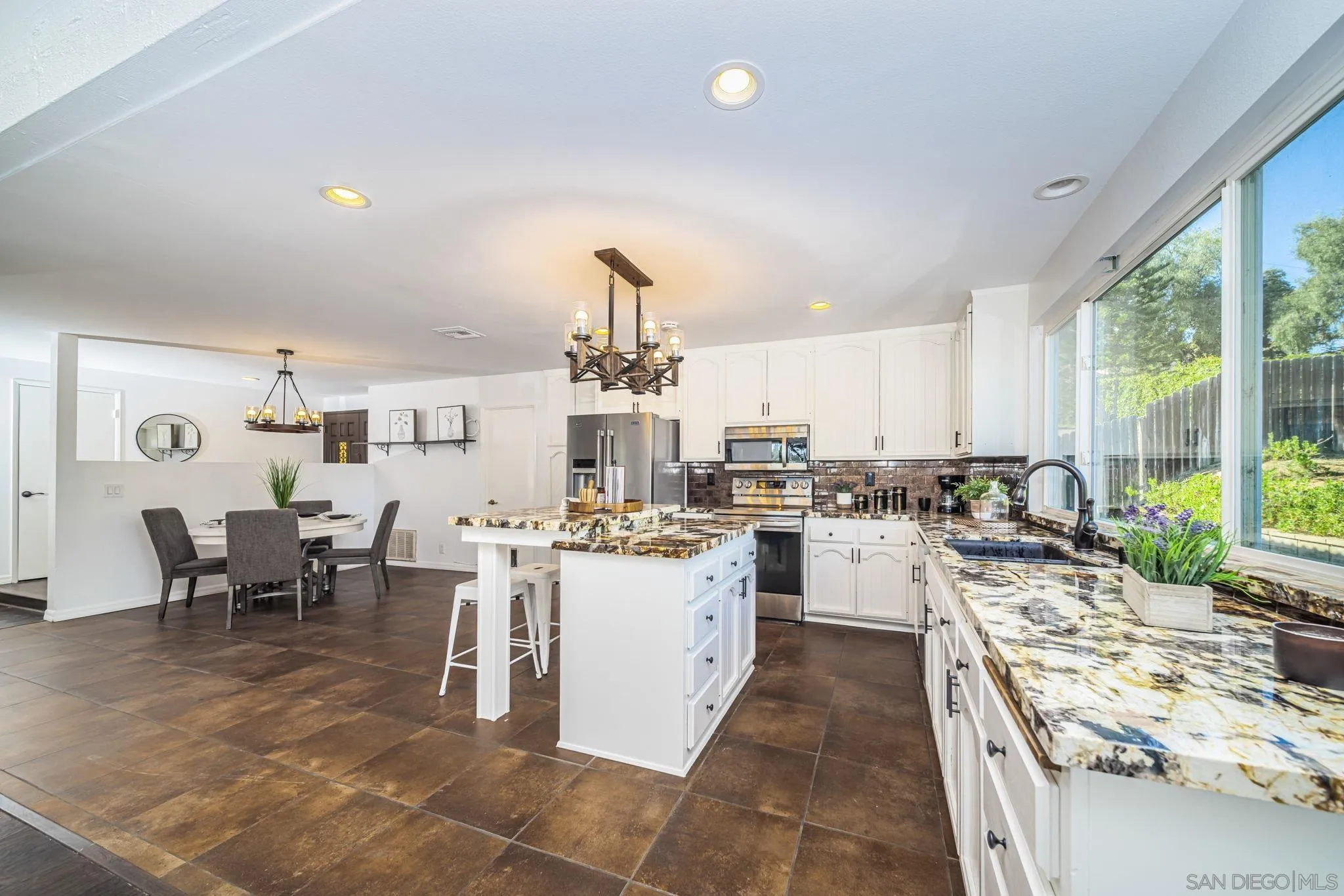1396 Friends Way Fallbrook, CA 92028 - Photo 2 of 52 a kitchen with lots of counter top space and dining table