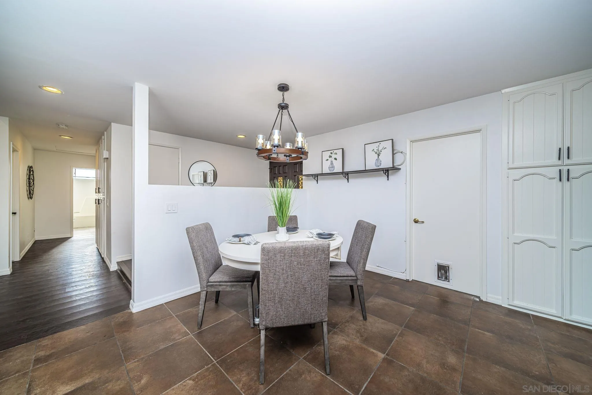 1396 Friends Way Fallbrook, CA 92028 - Photo 10 of 52 a dining room with furniture a chandelier and wooden floor