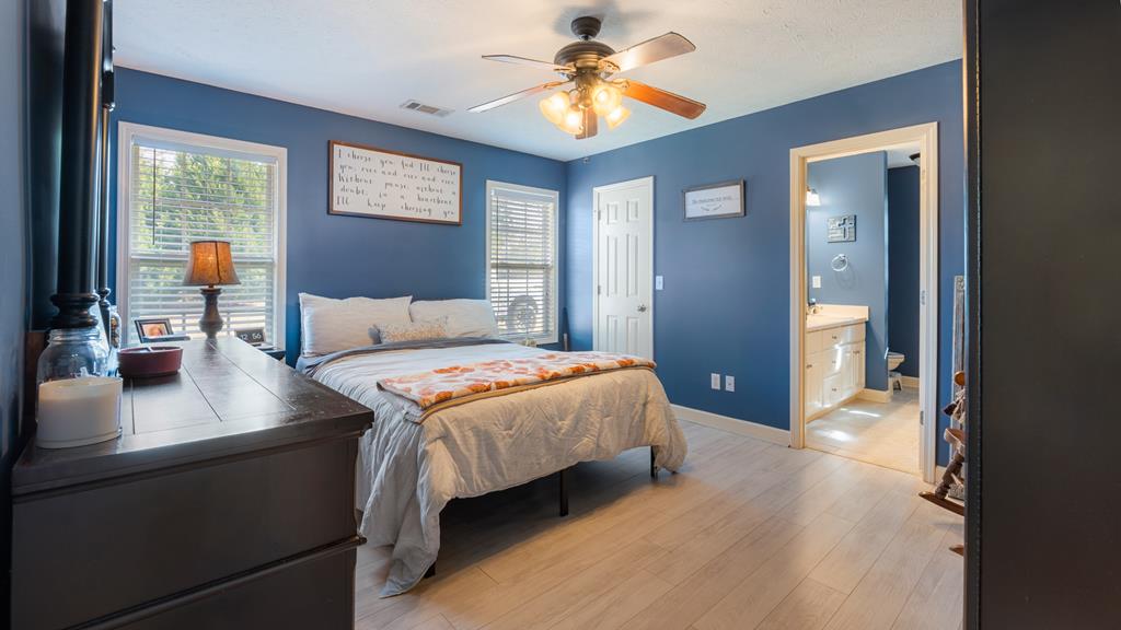 165 Firetower Road Buena Vista, GA 31803 - Photo 12 of 30 a bedroom with a bed and a chandelier