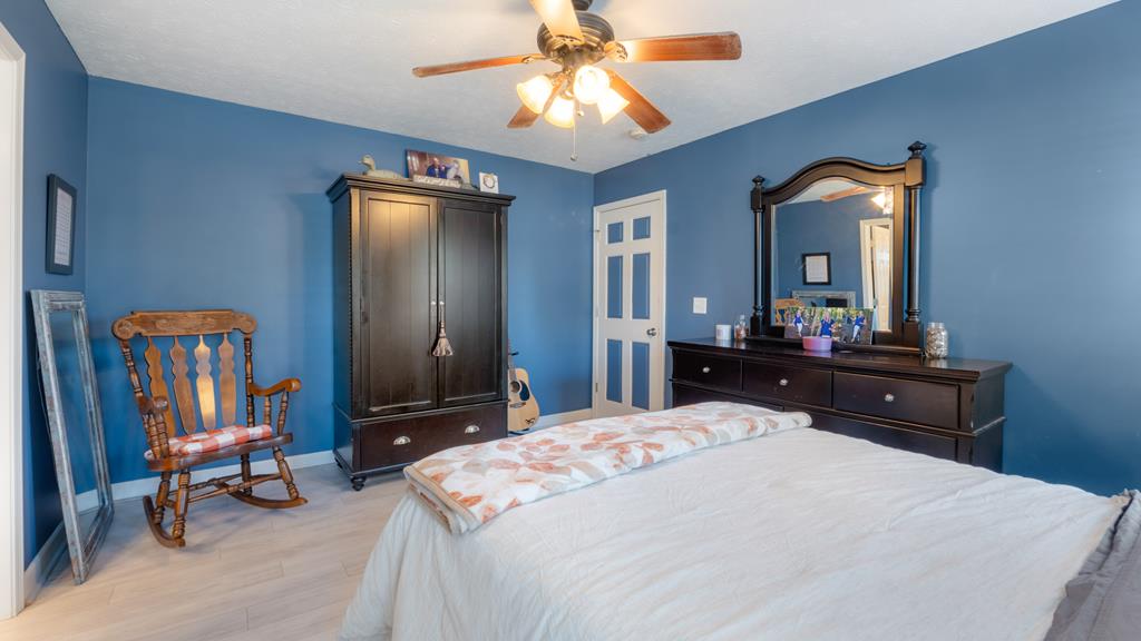 165 Firetower Road Buena Vista, GA 31803 - Photo 13 of 30 a bedroom with a bed a dresser and large mirror