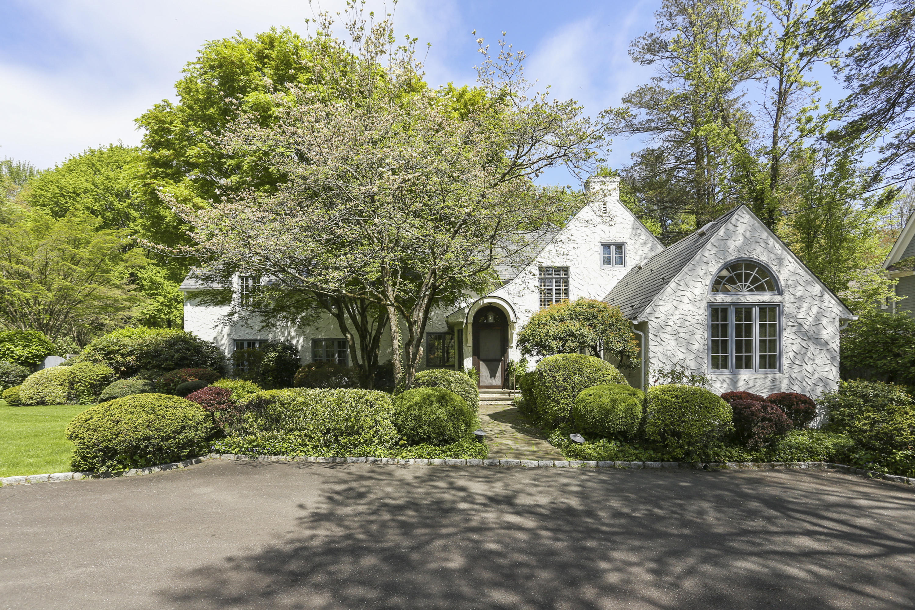 5 Meadowbrook Road Darien, CT 06820 - Photo 1 of 40 a view of a white house with a yard and potted plants