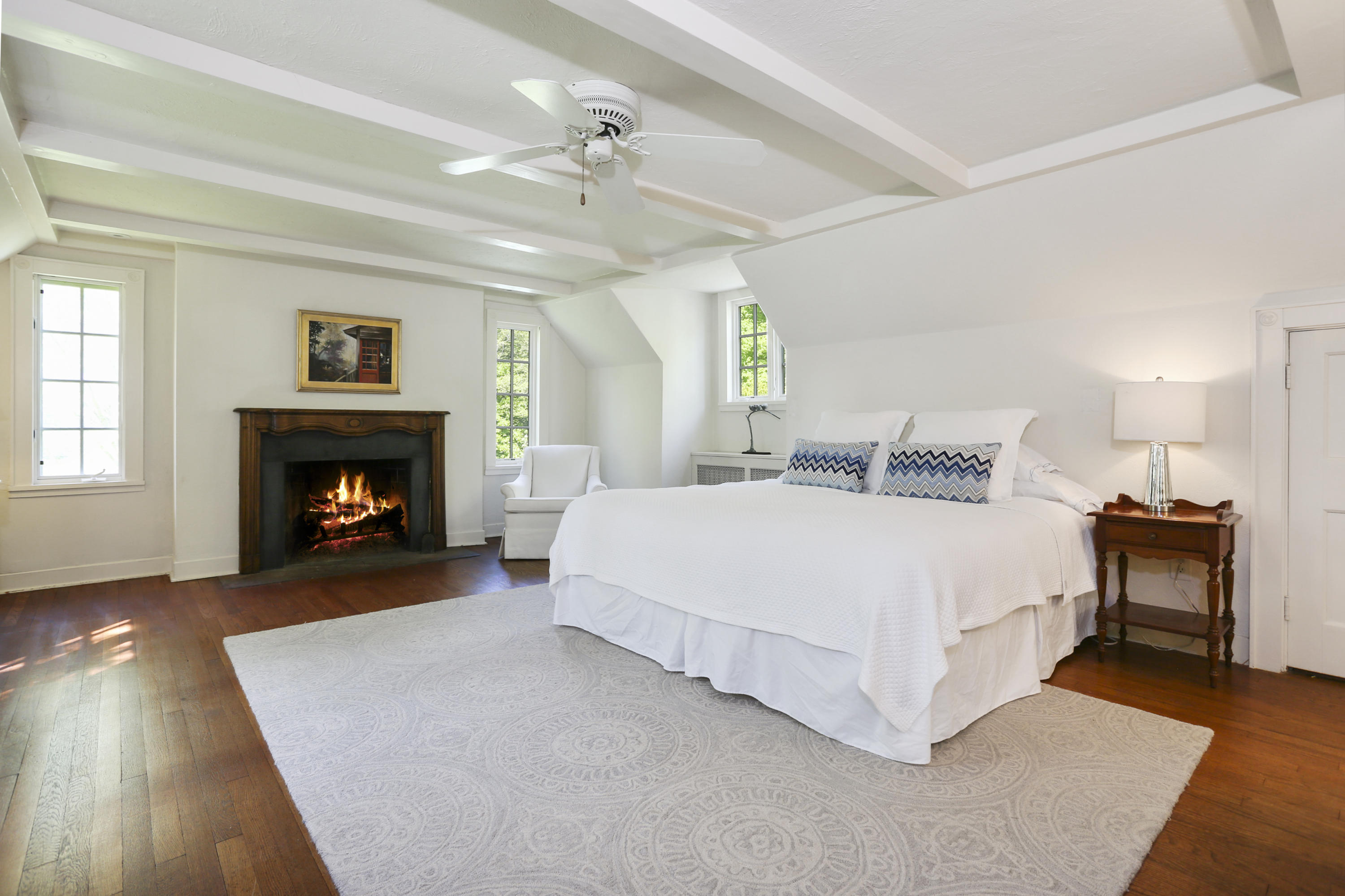 5 Meadowbrook Road Darien, CT 06820 - Photo 21 of 40 a spacious bedroom with a bed and a fireplace