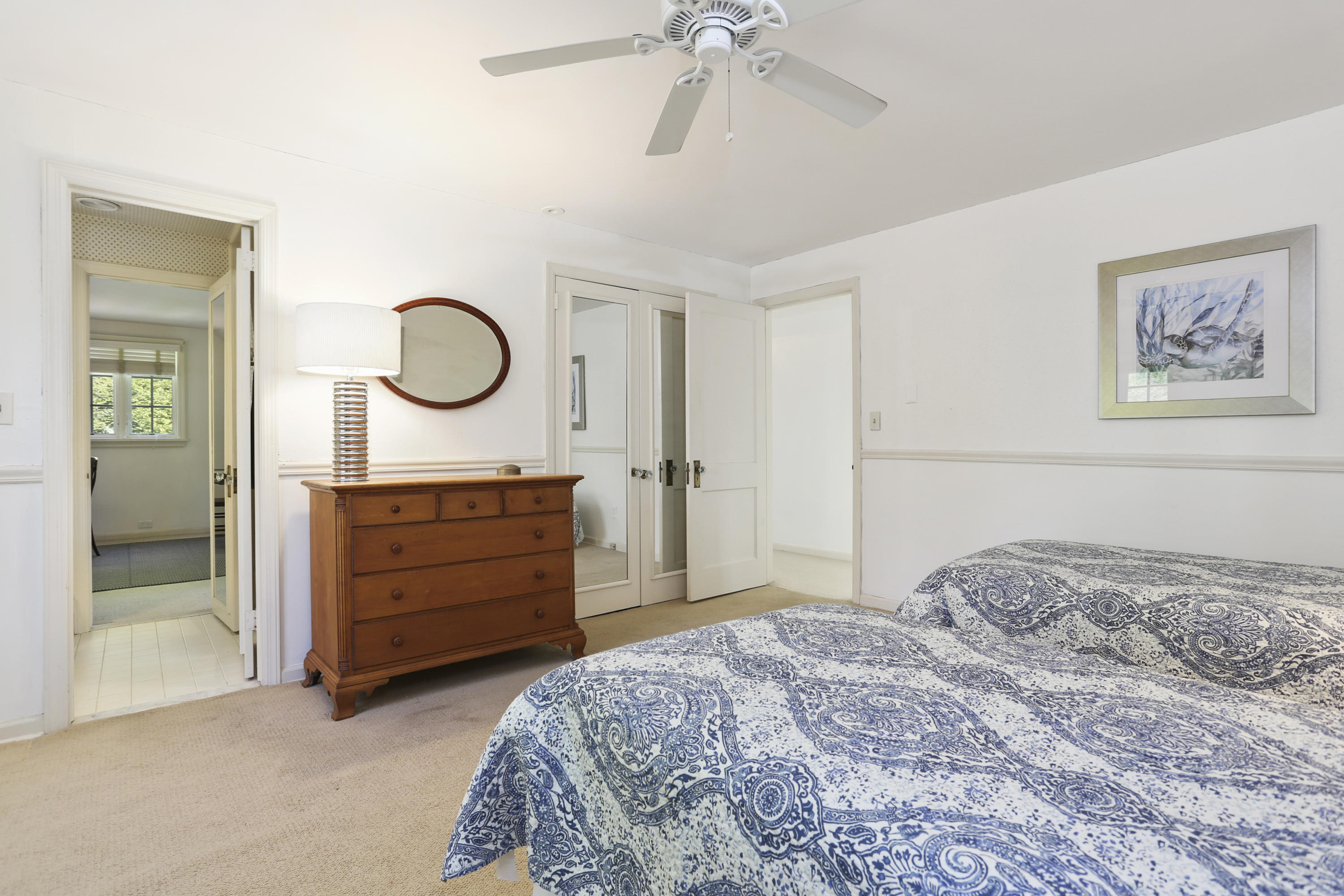 5 Meadowbrook Road Darien, CT 06820 - Photo 28 of 40 a bedroom with a bed and a chandelier