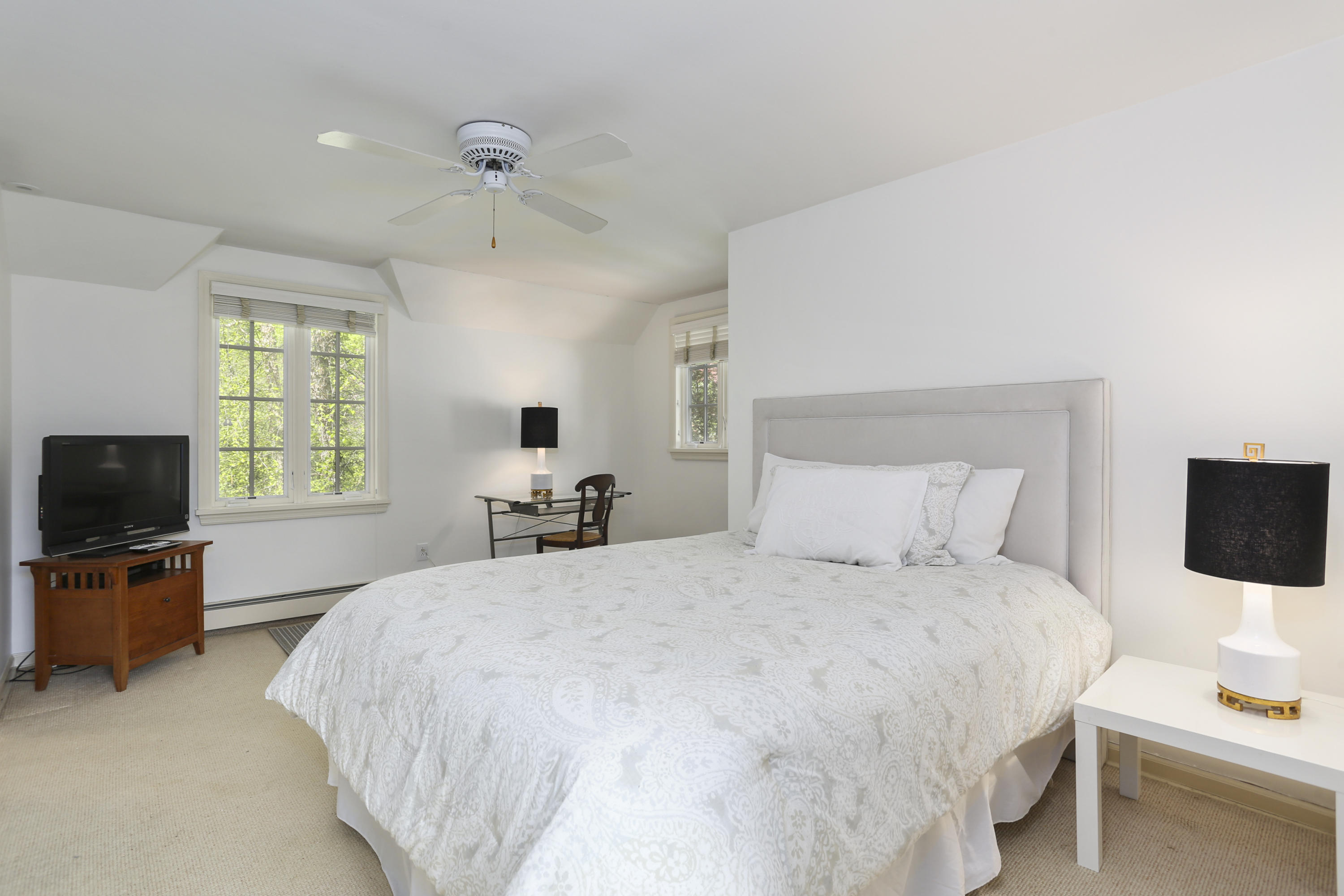 5 Meadowbrook Road Darien, CT 06820 - Photo 30 of 40 a bedroom with a bed and a flat screen tv