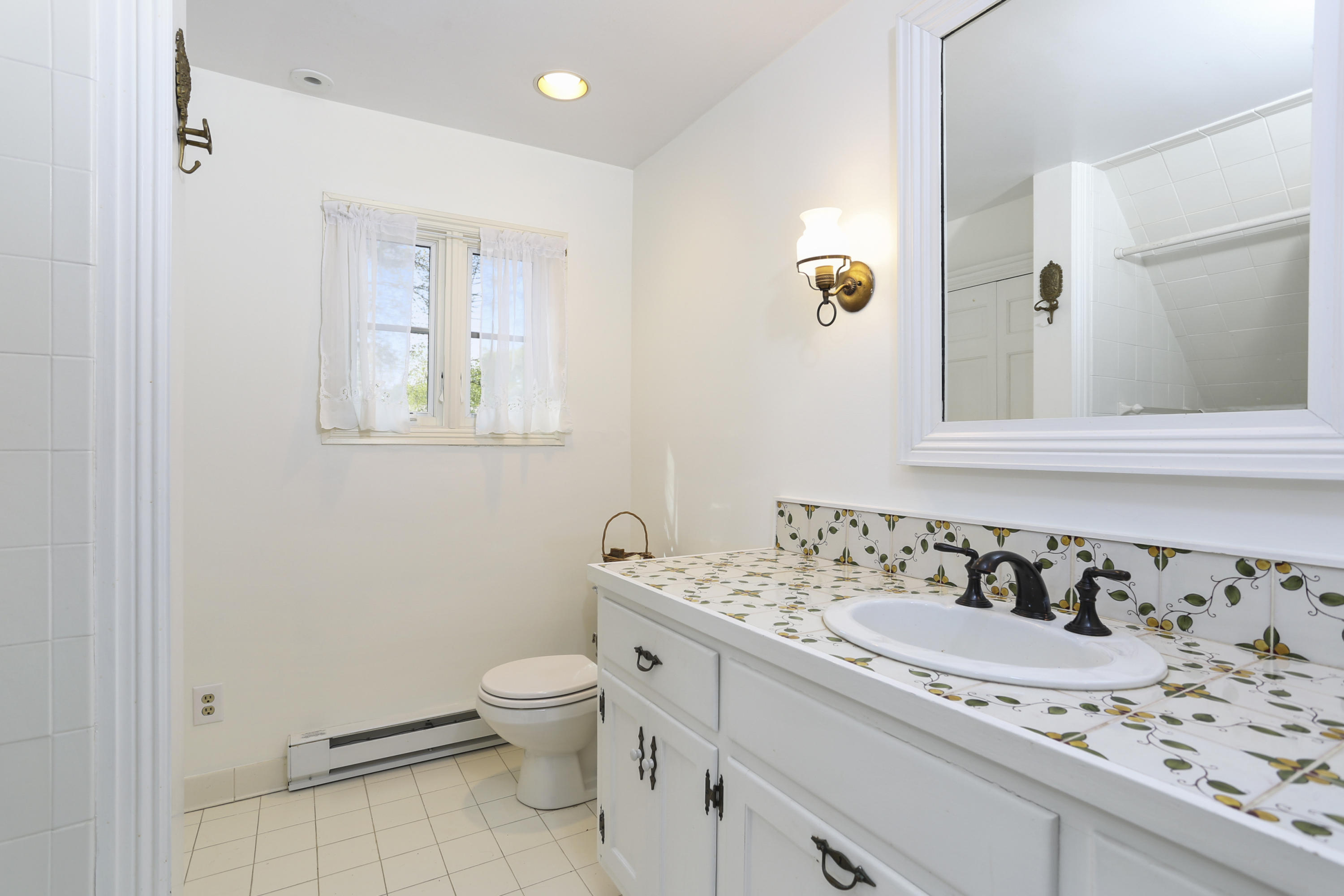 5 Meadowbrook Road Darien, CT 06820 - Photo 31 of 40 a bathroom with a granite countertop sink a toilet and mirror