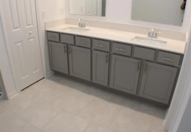 a bathroom with a sink and vanity
