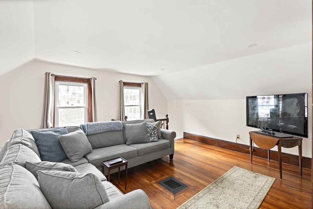 55 Main Street Somerville, MA 02145 - Photo 19 of 28 a living room with furniture and a flat screen tv
