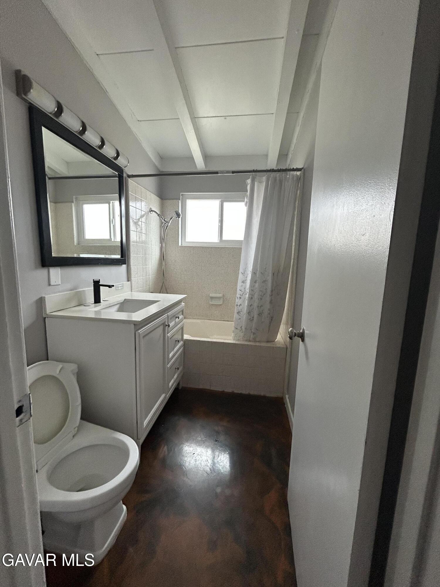 44021 3rd Street East Lancaster, CA 93535 - Photo 11 of 16 a bathroom with a toilet sink and mirror