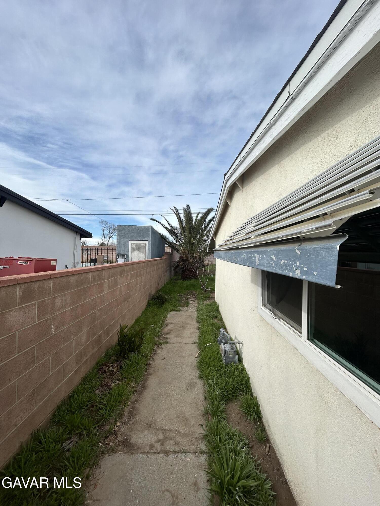 44021 3rd Street East Lancaster, CA 93535 - Photo 16 of 16 a view of a pathway of a house with a small yard