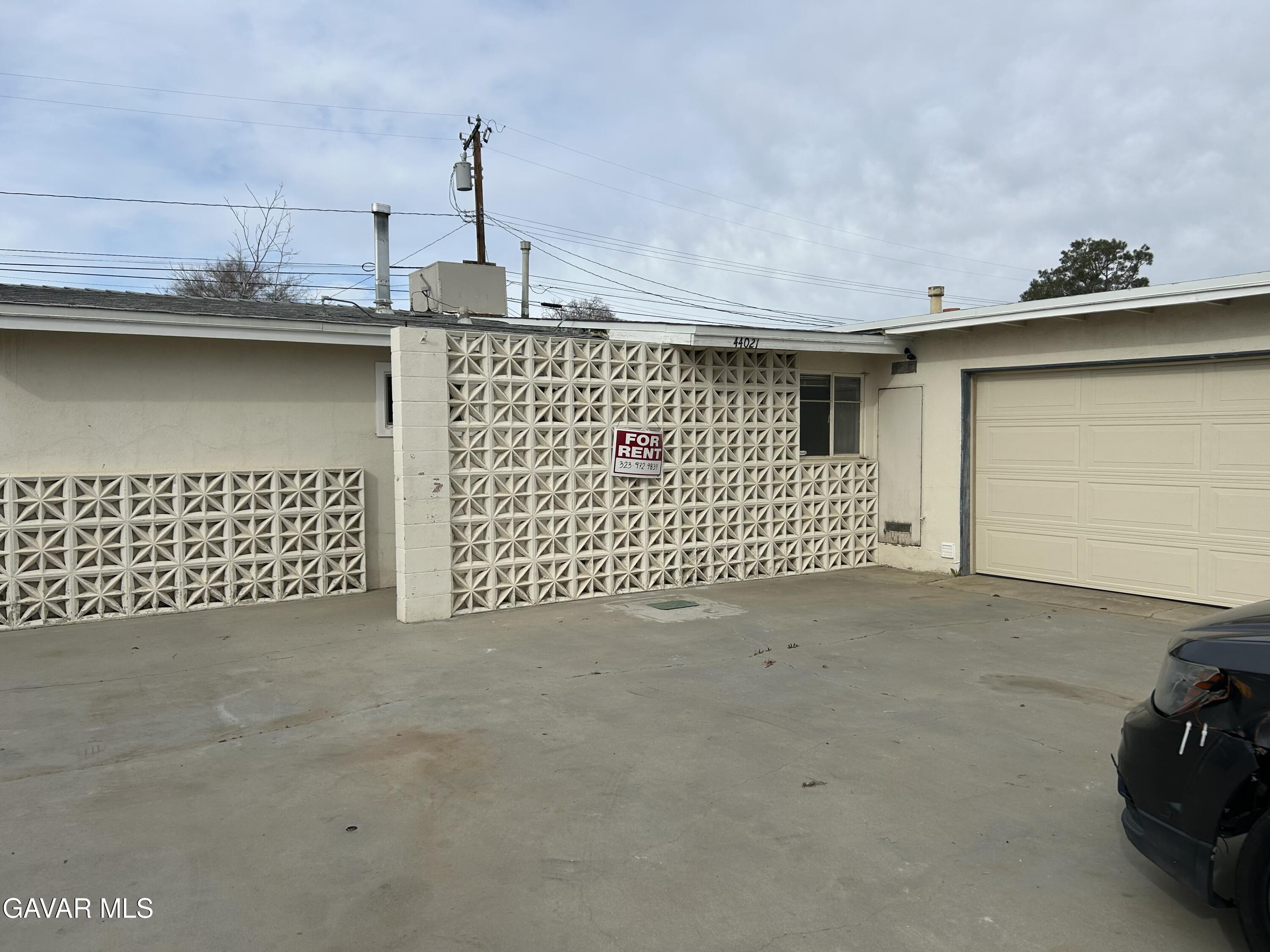 44021 3rd Street East Lancaster, CA 93535 - Photo 3 of 16 a view of a street with garage