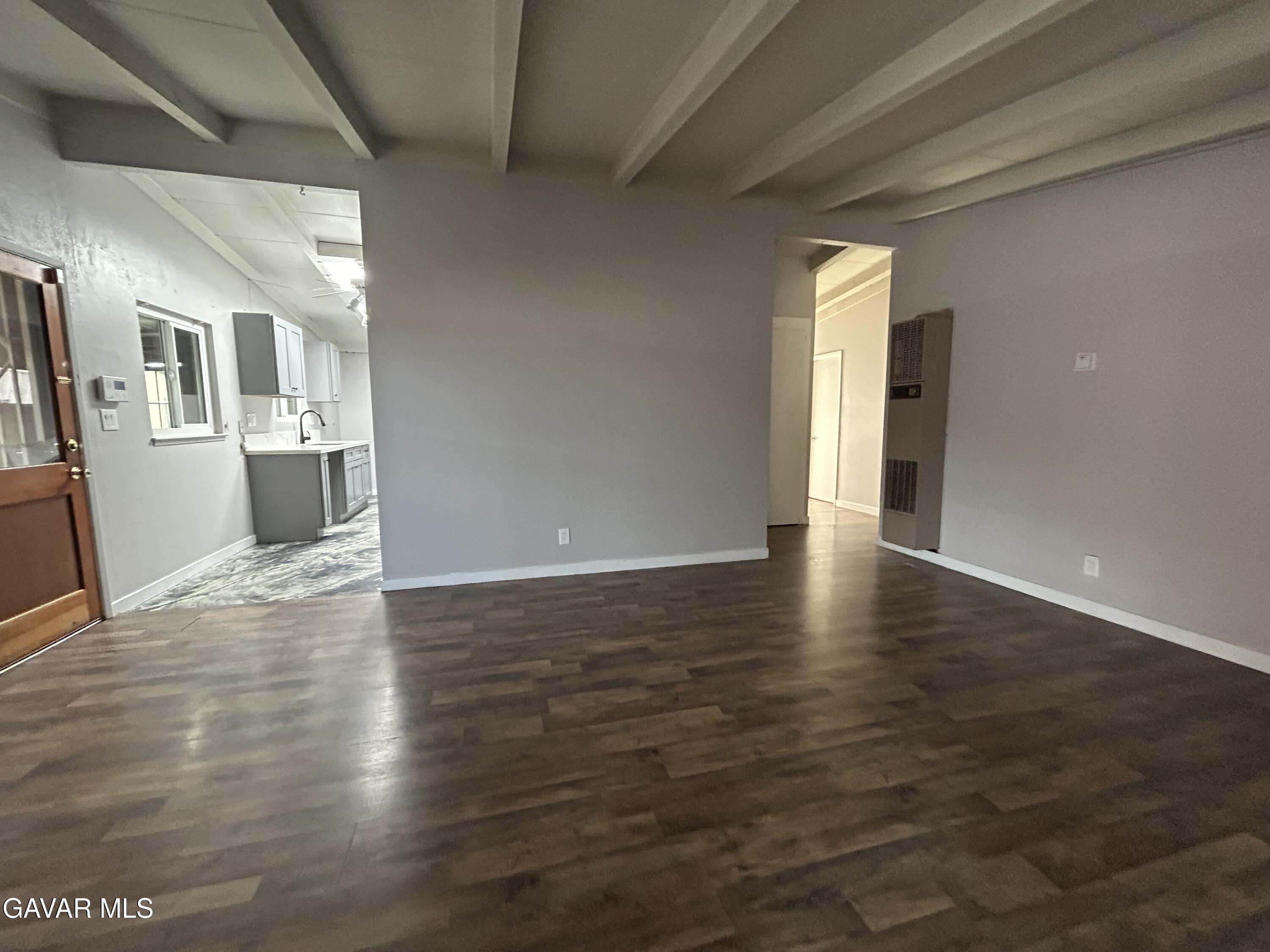 44021 3rd Street East Lancaster, CA 93535 - Photo 5 of 16 a view of an empty room with wooden floor and a window