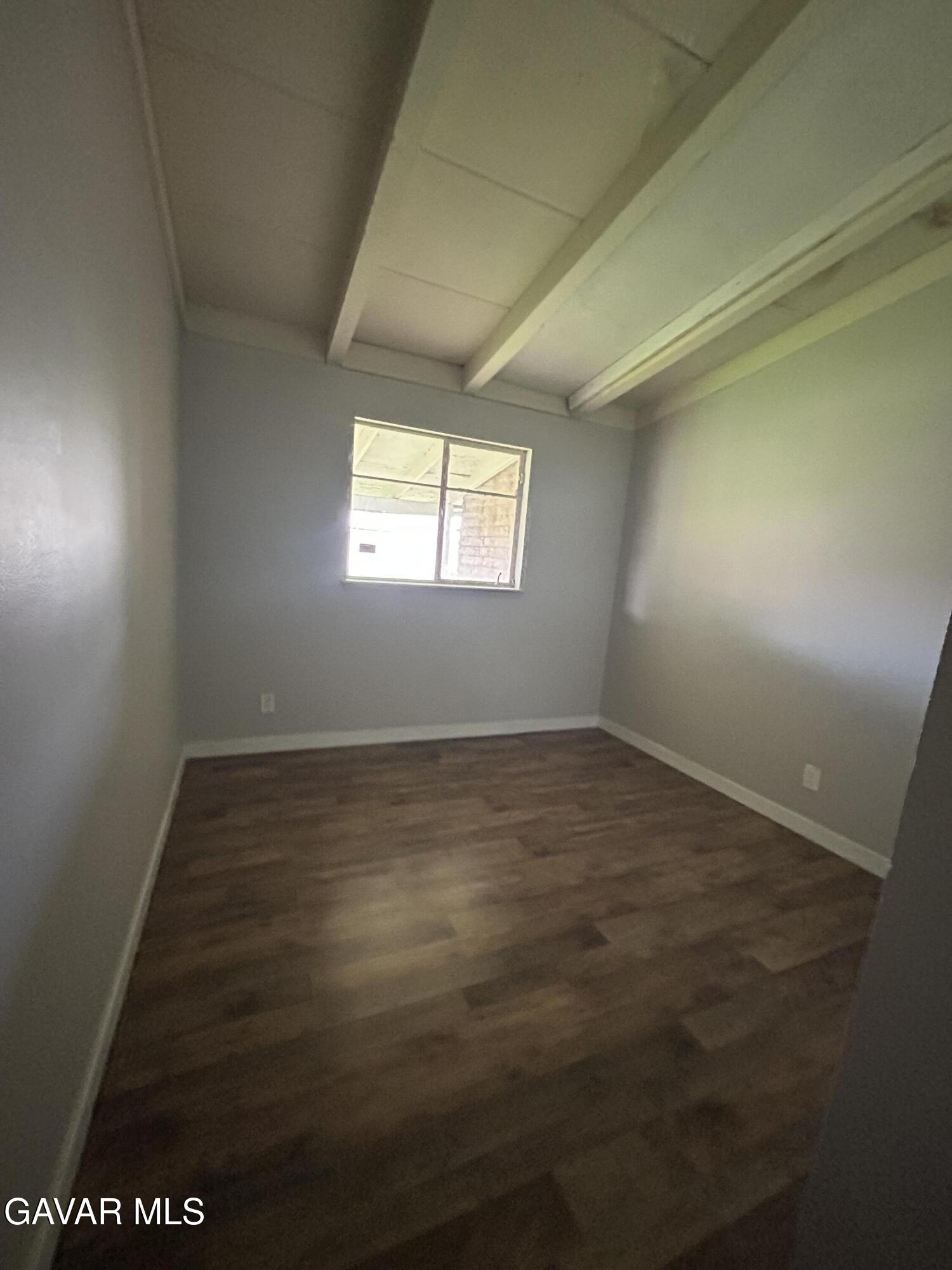 44021 3rd Street East Lancaster, CA 93535 - Photo 8 of 16 an empty room with wooden floor and windows