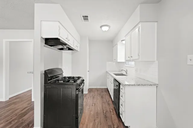 a kitchen with stainless steel appliances granite countertop a stove and a refrigerator
