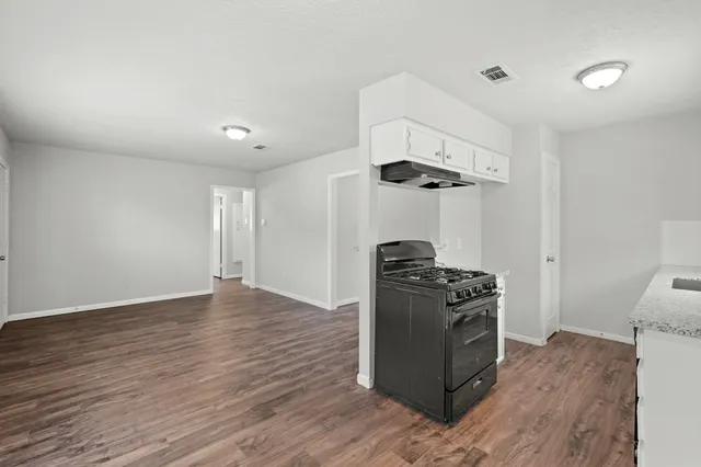 a kitchen with stainless steel appliances granite countertop a stove and a refrigerator