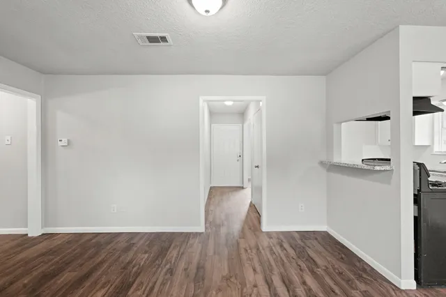 a view of a room with wooden floor
