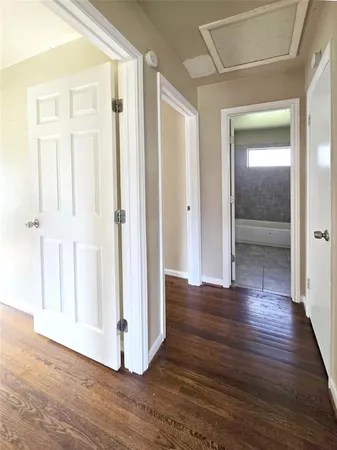 a view of a hallway with wooden floor