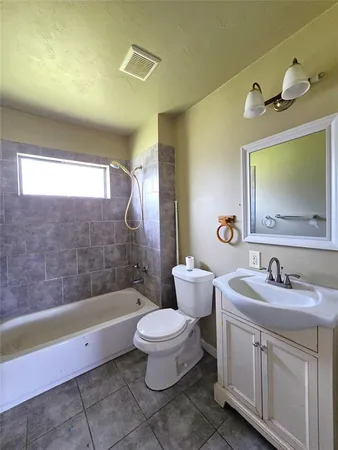 a bathroom with a double vanity sink toilet mirror and shower