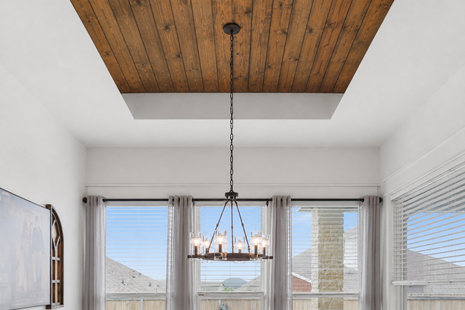 133 Greg Lane Jarrell, TX 76537 - Photo 12 of 24 Vaulted ceiling with wood-paneled inset and a suspended chandelier