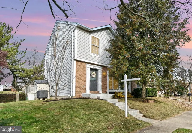 a view of a house with a yard and tree