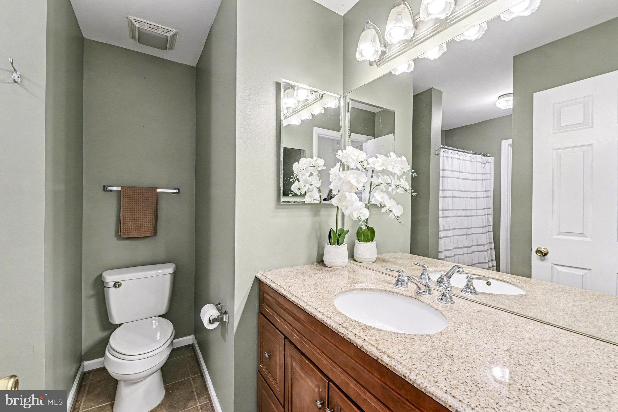 310 Talbot Court Abingdon, MD 21009 - Photo 14 of 24 a bathroom with a granite countertop toilet a sink and a mirror