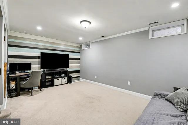 a living room with furniture and stairs