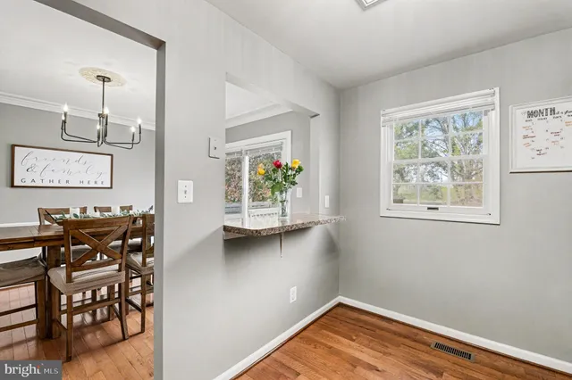 a kitchen with granite countertop wooden cabinets stainless steel appliances and a window