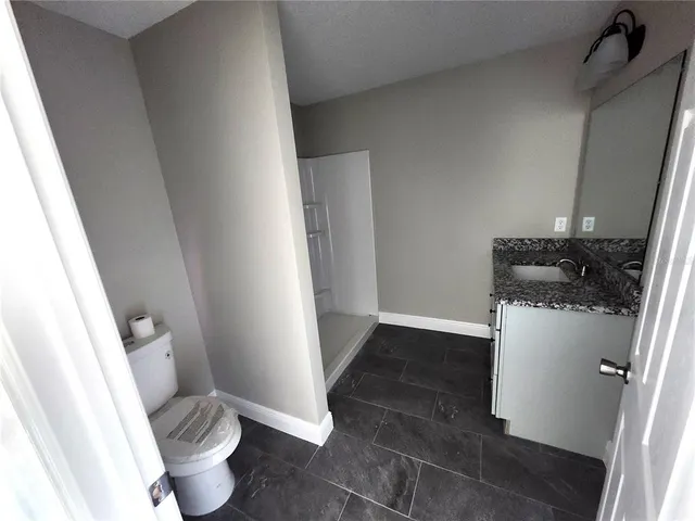a white toilet sitting next to a sink